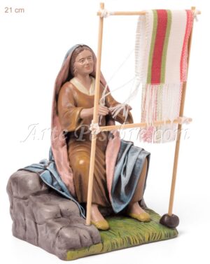 Pastora tejiendo alfombra