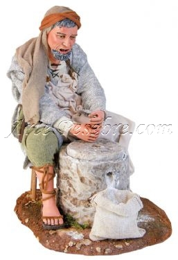 Pastor moliendo grano